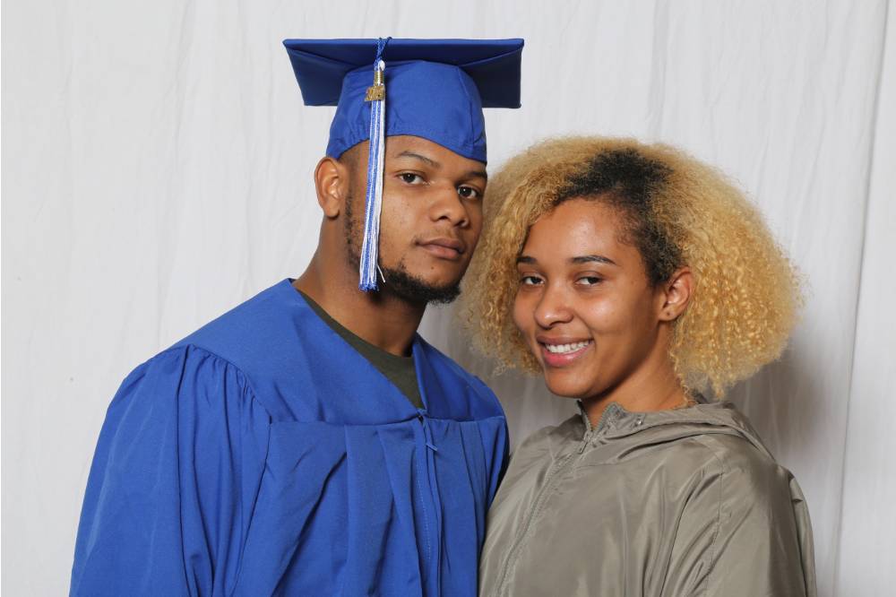 guy graduates next to girl in pic